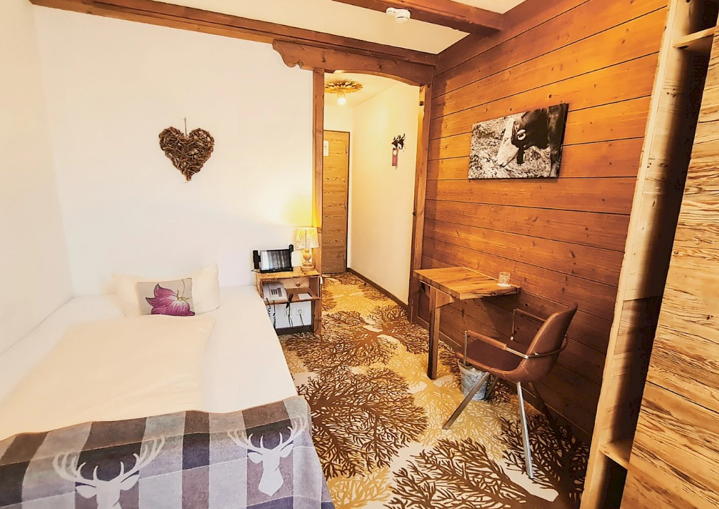 Overview of single room with bed, TV & lovely details