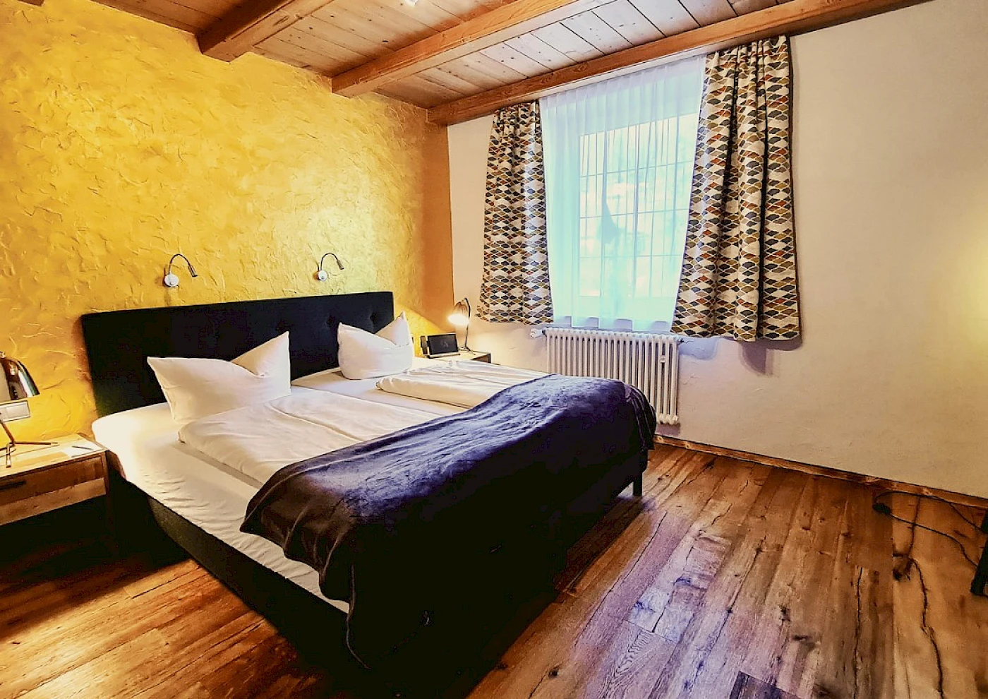 Double bed in a cosy room at a lakeside hotel