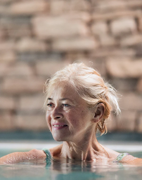 Woman enjoying pleasant water in an indoor pool